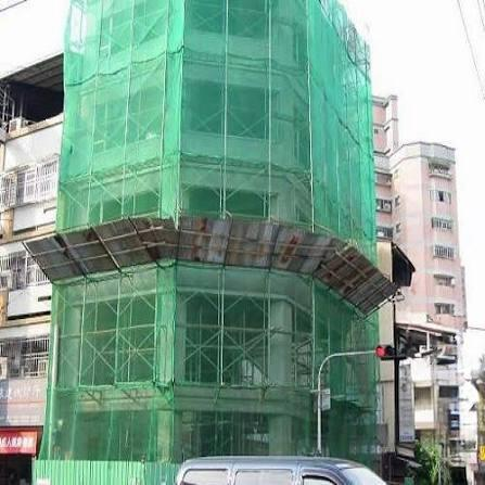 Green construction safety netting around a building